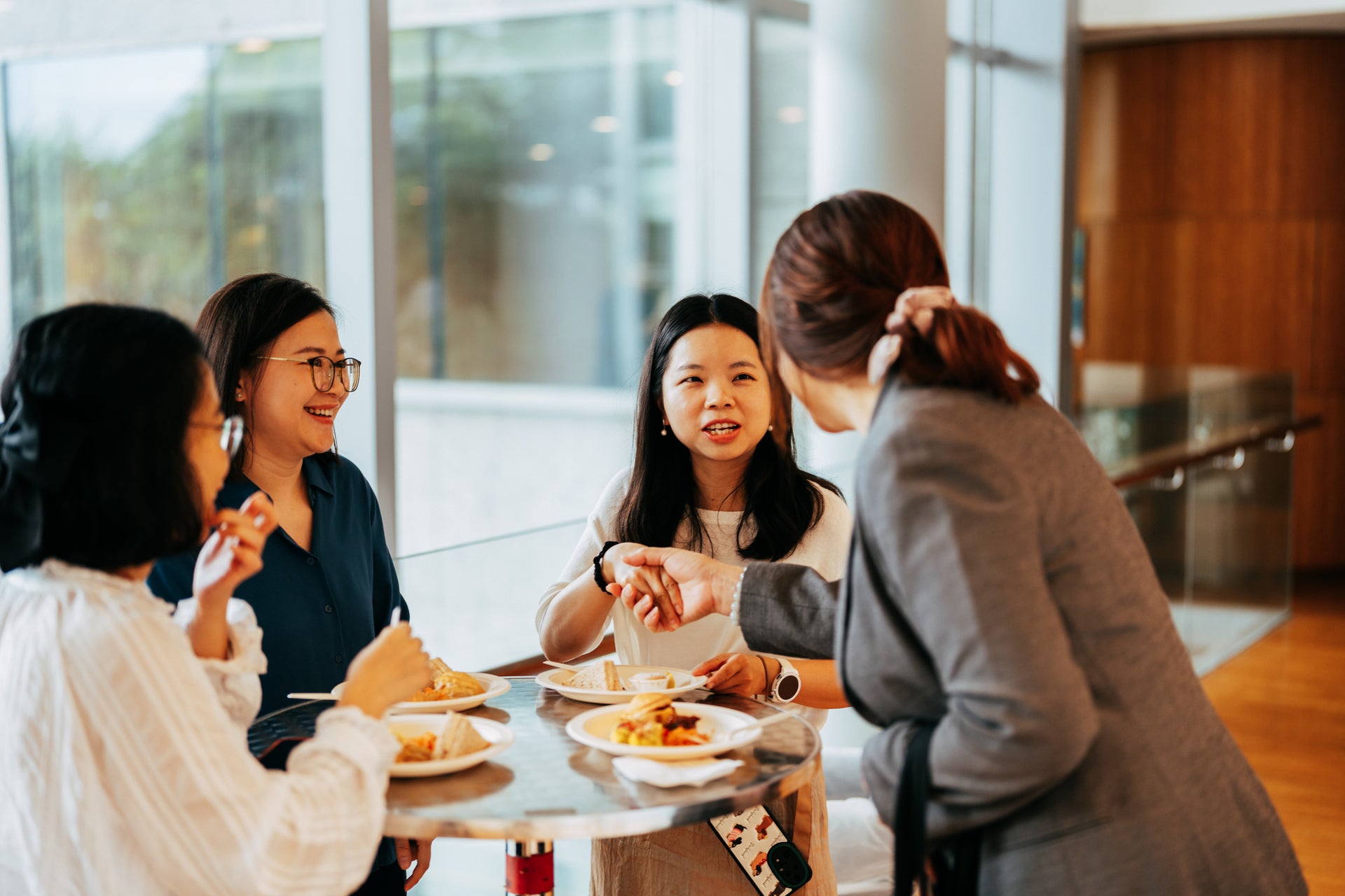 NUS Immersion Programme participants interacting with colleagues from the NUS hosting departments during the breakfast reception at University Hall Linkbridge