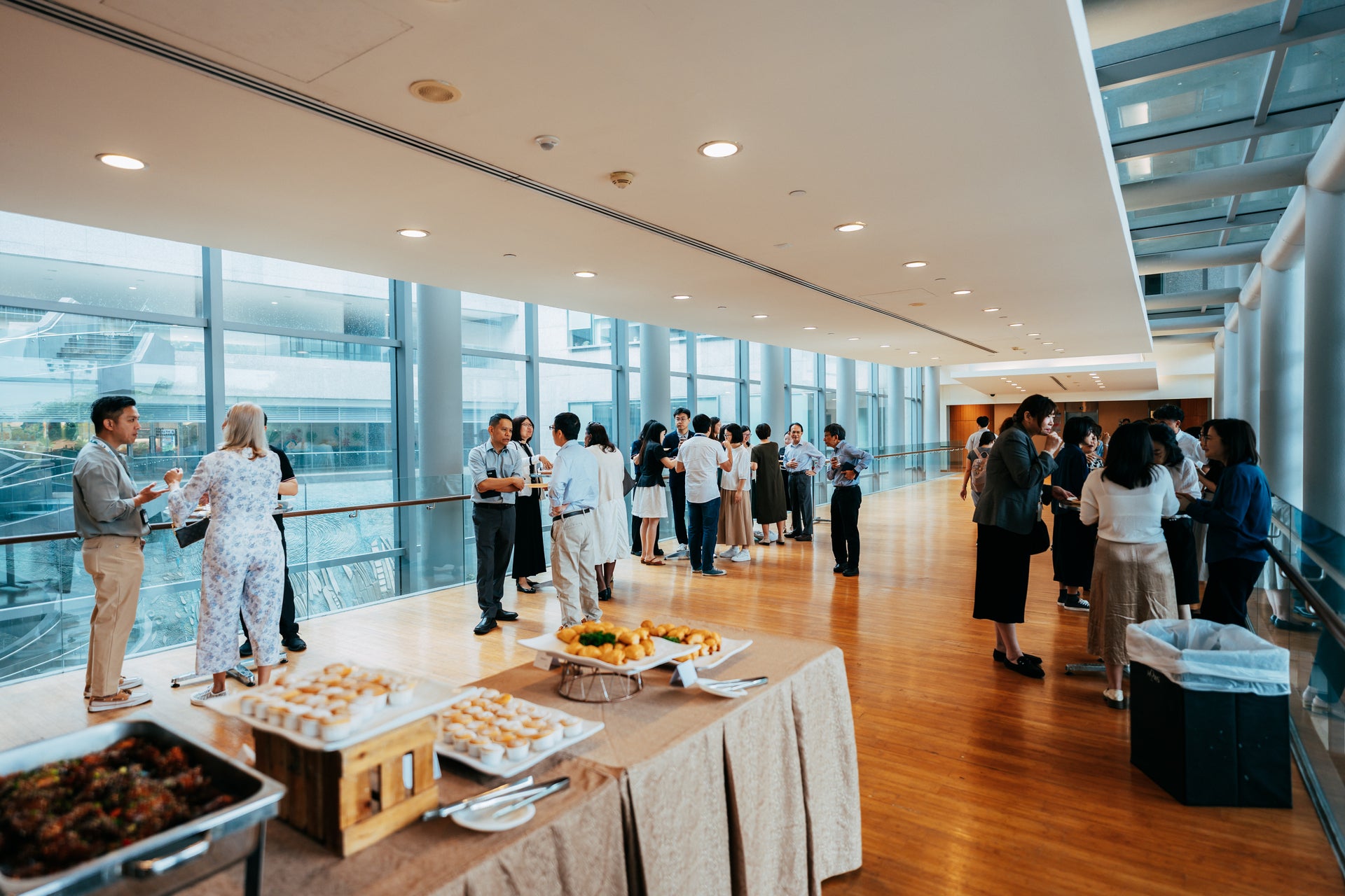 NUS Immersion Programme participants interacting with colleagues from the NUS hosting departments during the breakfast reception at University Hall Linkbridge